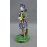 Early 19th century Portobello pottery figure of a Bagpiper, modelled standing in his tartan jacket