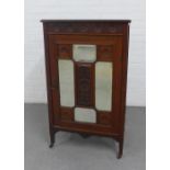 Late 19th / early 20th century mahognay cabinet with glazed door and shelved interior, on tapering