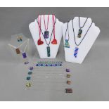 A collection of dicroic glass pendant necklaces, bracelets and earrings (21)