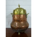 Copper and brass urn vessel, with handles to side and raised on three bun feet, 43cm high