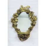 Floral giltwood mirror with pier shelf, the oval plate surmounted with a ribbon swag within a