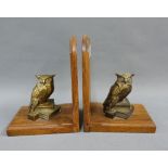 Pair of oak bookends, each with surmounted with a bronze patinated owl and stack of books, (2)