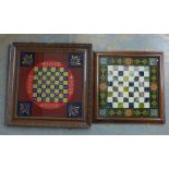 Verre eglomise chess board with red ground and gilt acanthus motifs, together with another smaller