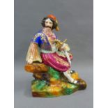 Continental porcelaneous figure of a Gent, modelled seated wearing Turkish style costume, on a