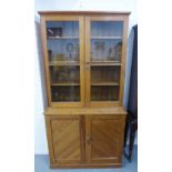 Pine bookcase cabinet, the top with a pair of glazed doors and shelved interior over a pair of