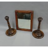 Pair of oak knop stemmed candlesticks and a small wall mirror with rectangular plate, 23cm high (3)