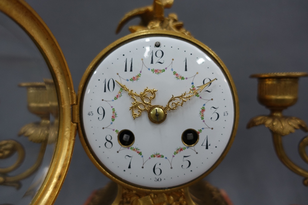 Gilt metal and pink hardstone clock garniture, the dial surmounted by birds, brass movement striking - Image 2 of 3