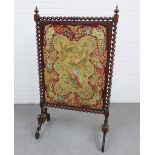 Victorian rosewood fire screen, with a spiral twist frame, containing a Berlin wool work panel,
