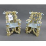 A pair of miniature rustic stoneware armchairs, modelled as branch's with flowers and with a blue