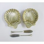 A pair of Victorian silver butter dishes of shell form complete with matching butter knives,