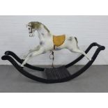 An Edwardian wooden rocking horse with grey dapple painted body, leather saddle and black rocking