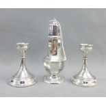 Pair of Birmingham silver candlesticks, 11cm high together with a silver sugar castor of typical