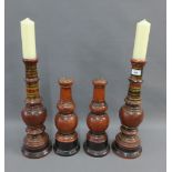 Two pairs of red painted baluster wooden candlesticks, tallest 46cm (4)