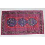 Eastern rug, red field, triple pole medallion and geometric borders, 185 x 104cm