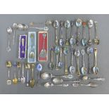 A collection of silver and white metal souvenir teaspoons (36)