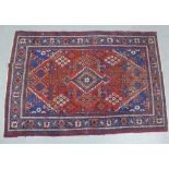 Eastern rug, red field and central blue medallion and spandrels, flowerhead border, 200 x 140cm