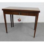 Mahogany foldover tea table, with a central frieze drawer and raised on tapering legs, 73 x 91cm