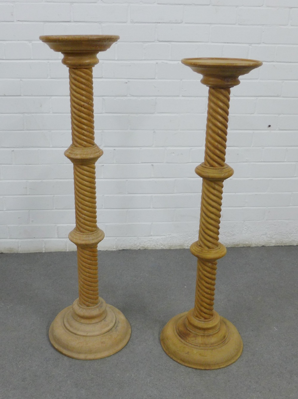 Two pine pedestal columns with circular tops and spiral stems, tallest 101cm (2)