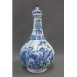 Chinese blue and white bottle neck vase and cover, with figures in a landscape pattern, 32cm high