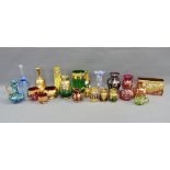 Collection of coloured Bohemian glass with enamelled flowers and gilt highlights to include vases,