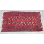 Eastern rug, red field, two rows of eleven guls, 225 x 117cm