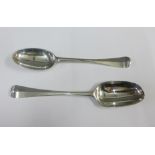 Two George III Irish silver serving spoons, Hanoverian pattern with engraved crests, one by