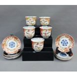 Set of Chinese cups and saucers, with blue and white flowers, iron red foliage and gilt 'Deer'