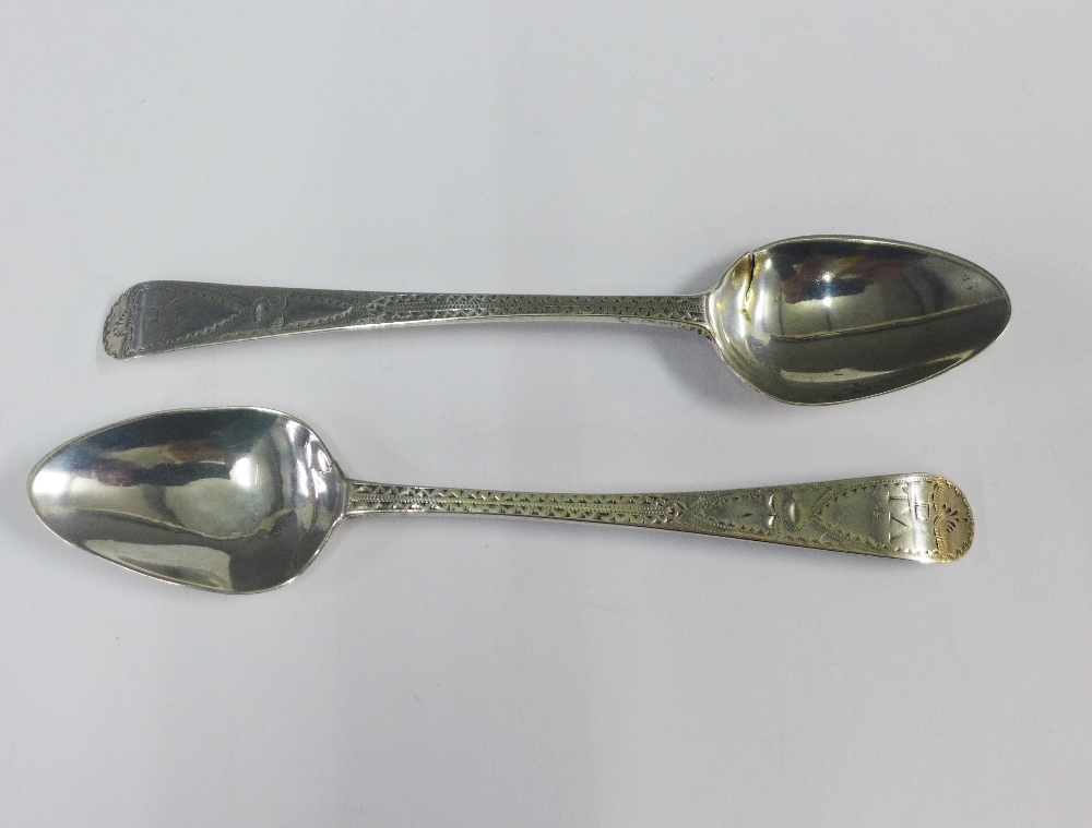 Pair of Georgian silver teaspoons with bright cut decoration and initials to the terminal, (2)