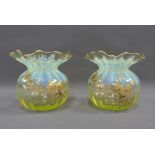 A pair of uranium and opaline glass posy vases with frilled rims and gilded flowers, 11cm high