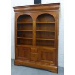 Large cherrywood bookcase cabinet, the cornice over two arched recess containing adjustable