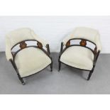 A pair of early 20th century armchairs with upholstered back, arms and seat, with mahognay and