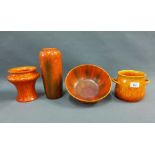 A collection of Pilkingtons Royal Lancastrian orange glazed pottery to include two vases, a bowl and