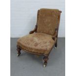 Late 19th century upholstered chair with mahogany frame and legs, with brass caps and ceramic