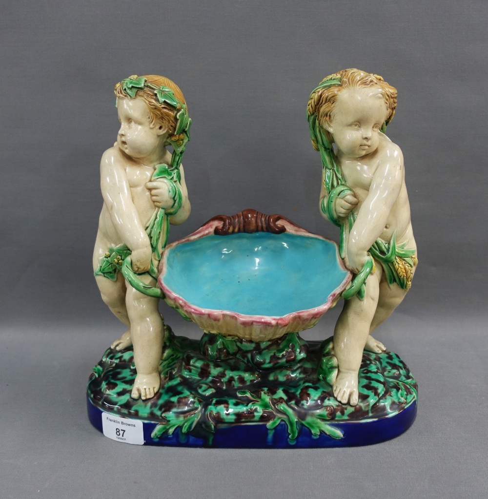 19th century Minton Majolica comport with two putti representing the Seasons, date code for 1865,