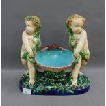 19th century Minton Majolica comport with two putti representing the Seasons, date code for 1865,