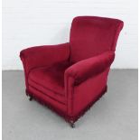 Early 20th century armchair with red velvet upholstery, mahogany legs with brass caps and ceramic