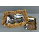 Basket containing a large collection of silver plated souvenir teaspoons, along with a wooden