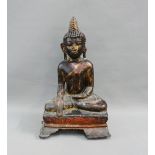 Patinated metal Buddha, modelled seated in contemplative pose, on a rectangular cushioned base