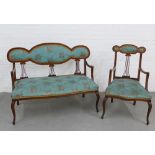 Edwardian two piece parlour suite comprising a two seater settee and armchair, with floral