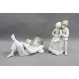 Lladro figure of a boy, modelled lying down and reading with his puppy, 18cm, together with