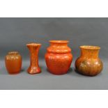 A collection of Pilkingtons Royal Lancastrian orange glazed pottery to include four vases of various