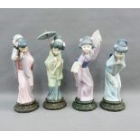 Set of four Lladro Geisha girl figures to include one with parasol, another holding two fans, (one