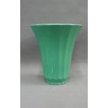 Keith Murray for Wedgwood, a green glazed vase with flared rim and fluted tapering form, with