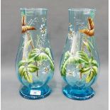 Pair of blue glass vases panelled with flower and foliage pattern in coloured enamels, with white