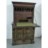 A part 18th century oak escritoire with a drop down fallfront and pigeon holes and drawers to the