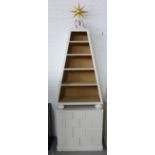 An unusual white painted bookcase cabinet, with a giltwood star over a set of five open shelves