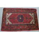 Eastern rug, the red field with a pole medallion and ivory spandrels, flowerhead border, 205 x