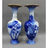 Pair of Royal Doulton blue and white vases with flared gilt edged rims and painted with children,