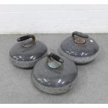 Three granite curling stones, one with a wooden handle, 27cm, (3)