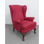 Red upholstered wing armchair on mahogany cabriole legs, 100 x 78cm
